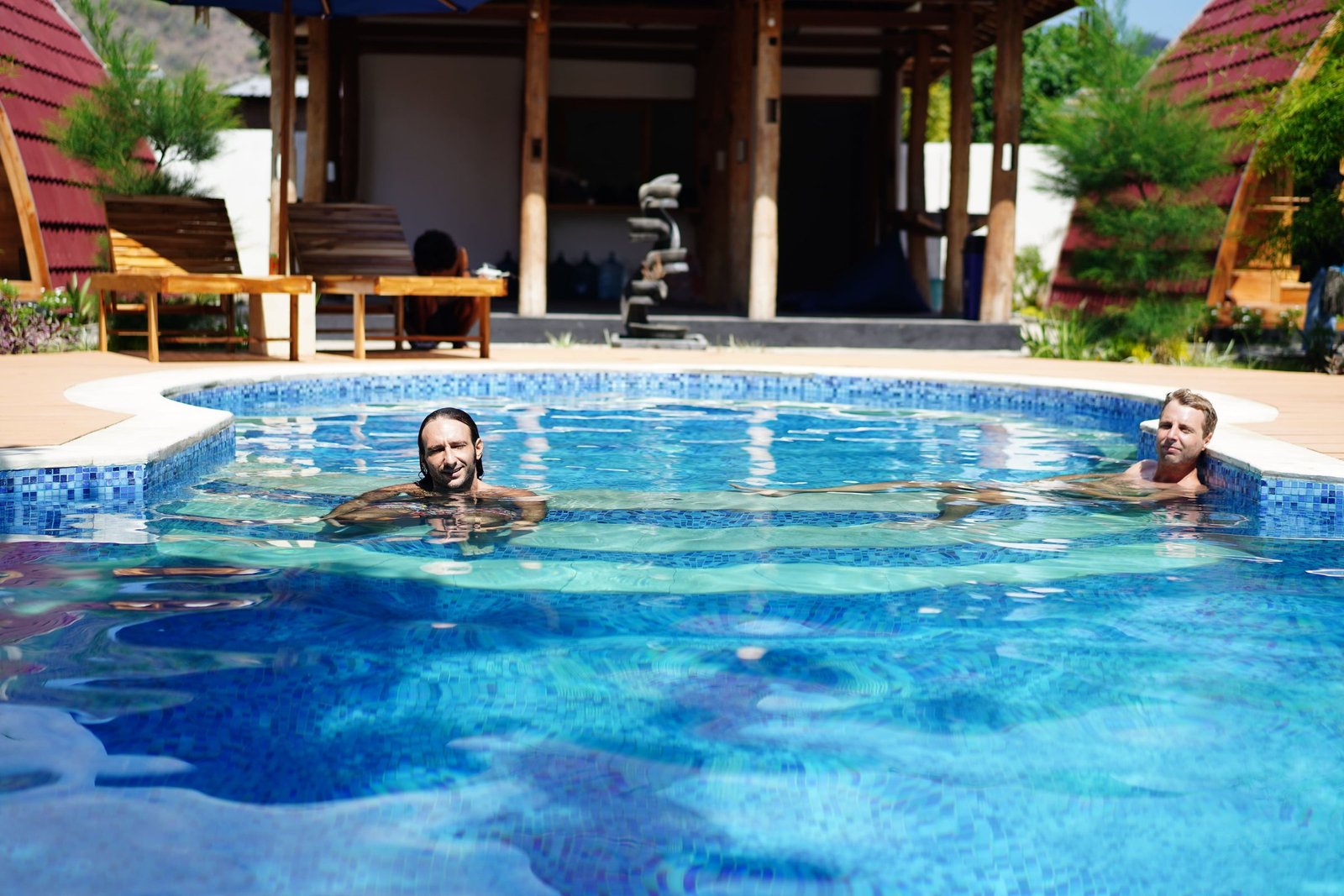 Guests in the swimming pool at Aisyah Villas